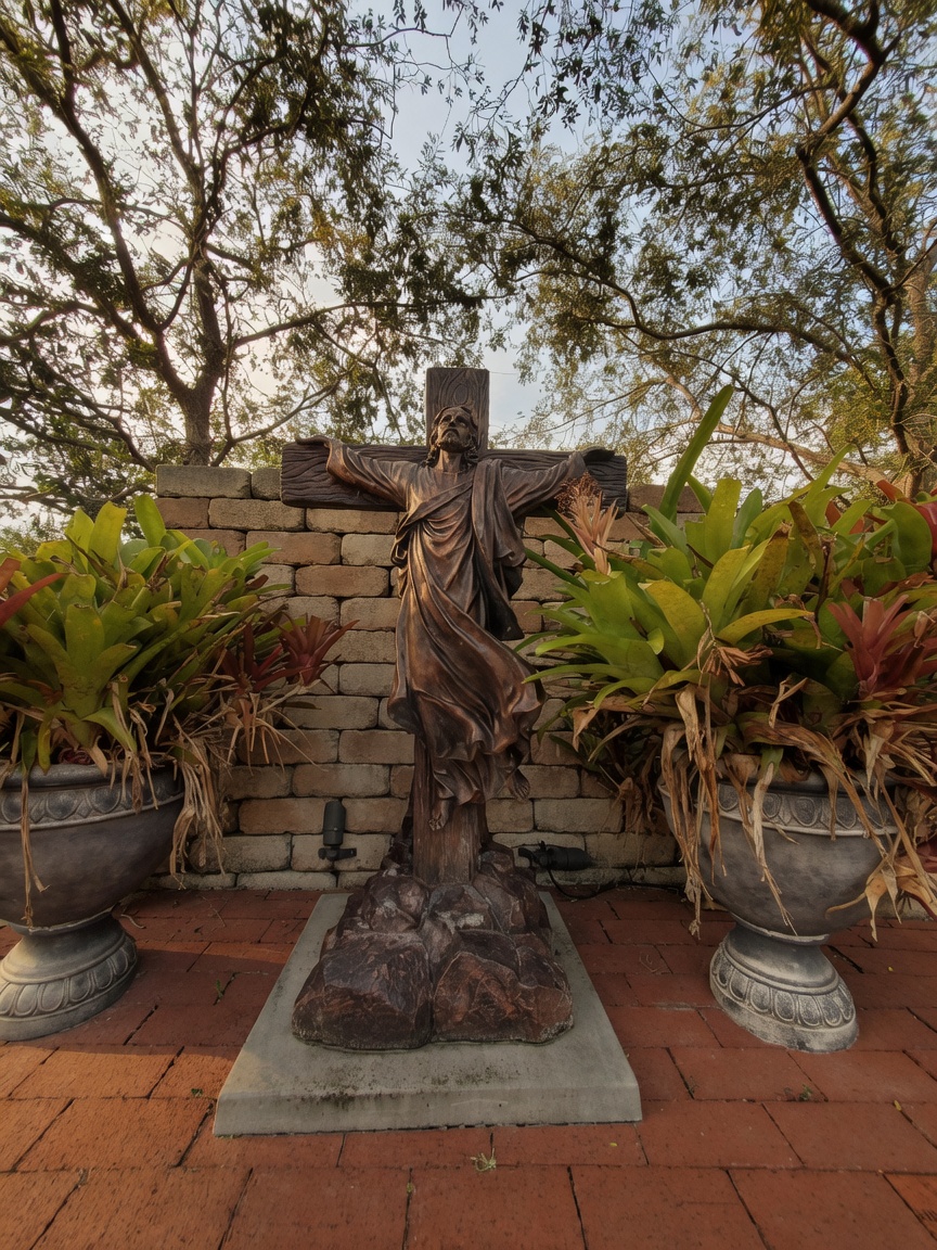The courtyard crucifix at Bear Lake UMC, with brick walks and Florida light.
