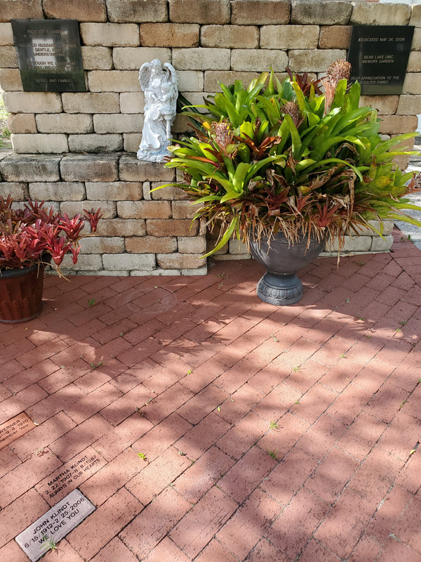 The church courtyard and memory garden with brick walks and oaks.