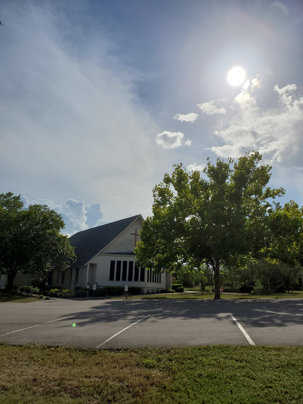 The church parking lot and sanctuary under Florida sun.